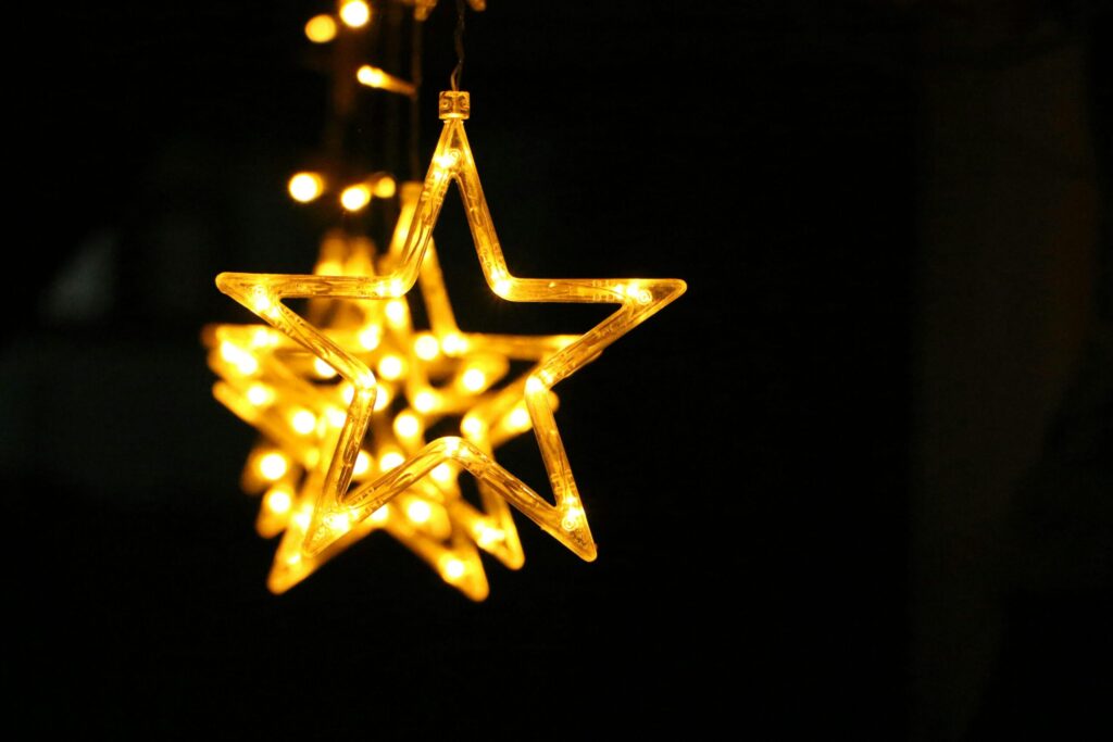 Close-up of glowing star-shaped string lights creating a warm ambiance